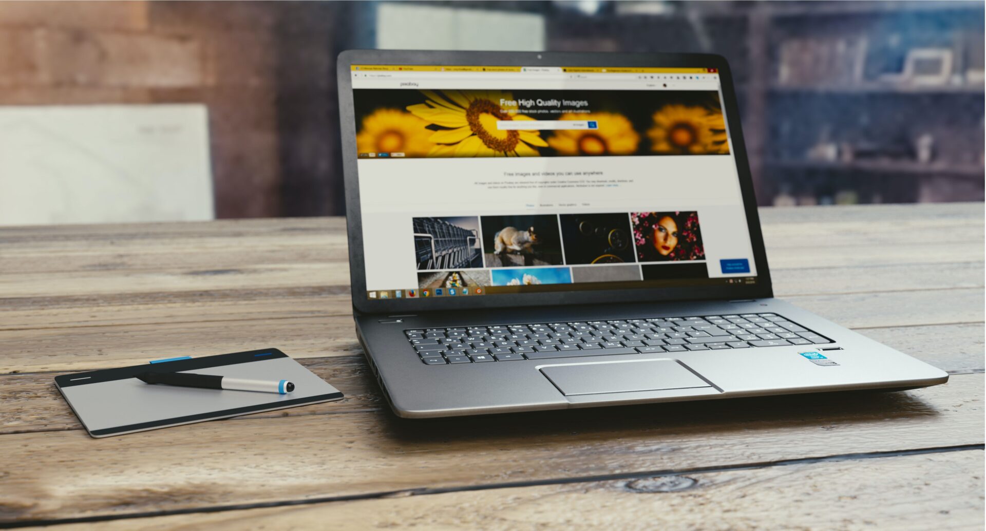 A laptop computer sitting on top of a wooden table.